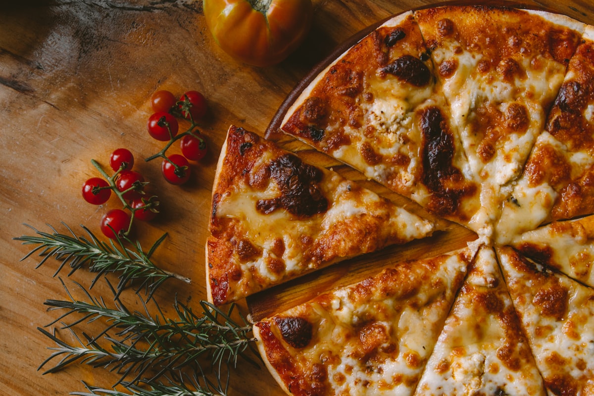 A fresh, hand-built pizza with cherry tomatoes and rosemary